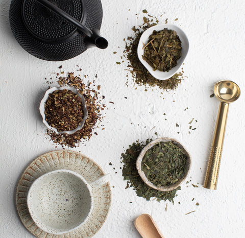  A selection of Australian native teas  displayed on a white surface, featuring Guradji Tisane among them.