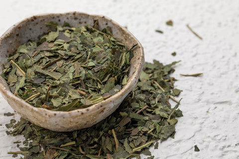 Close up of Guradji tea in a stone bowl on a white background